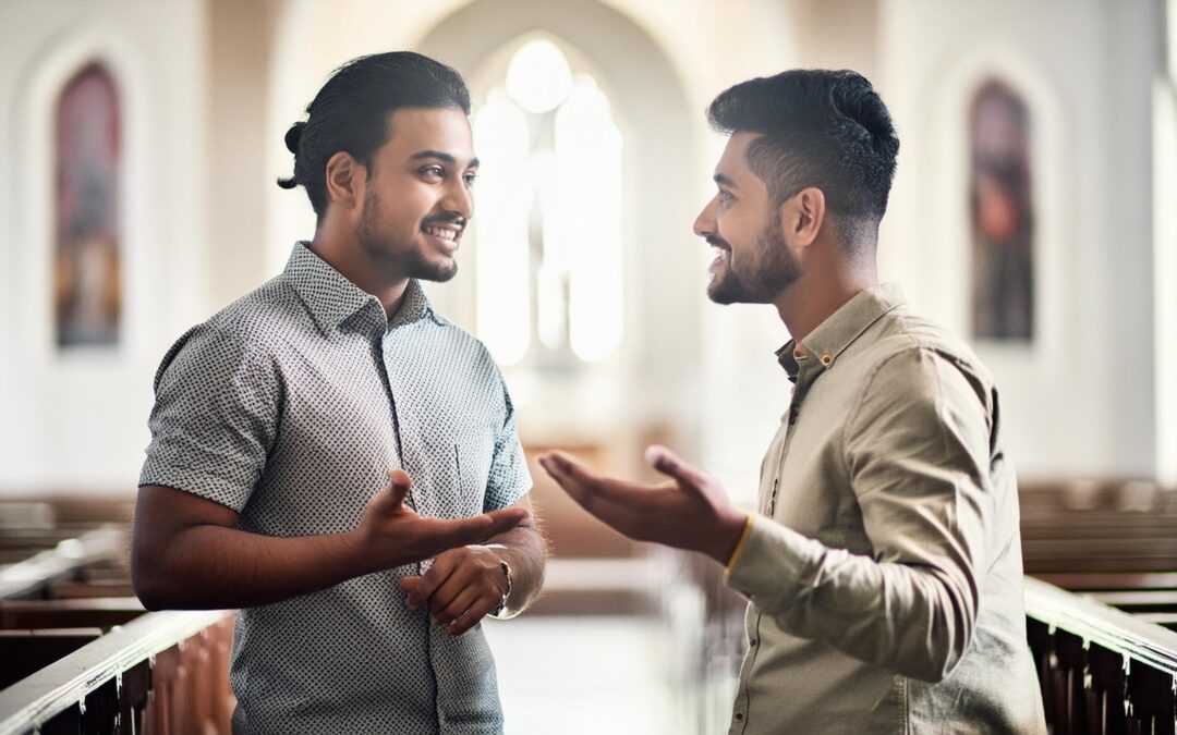 Two South Asian men talking in a church